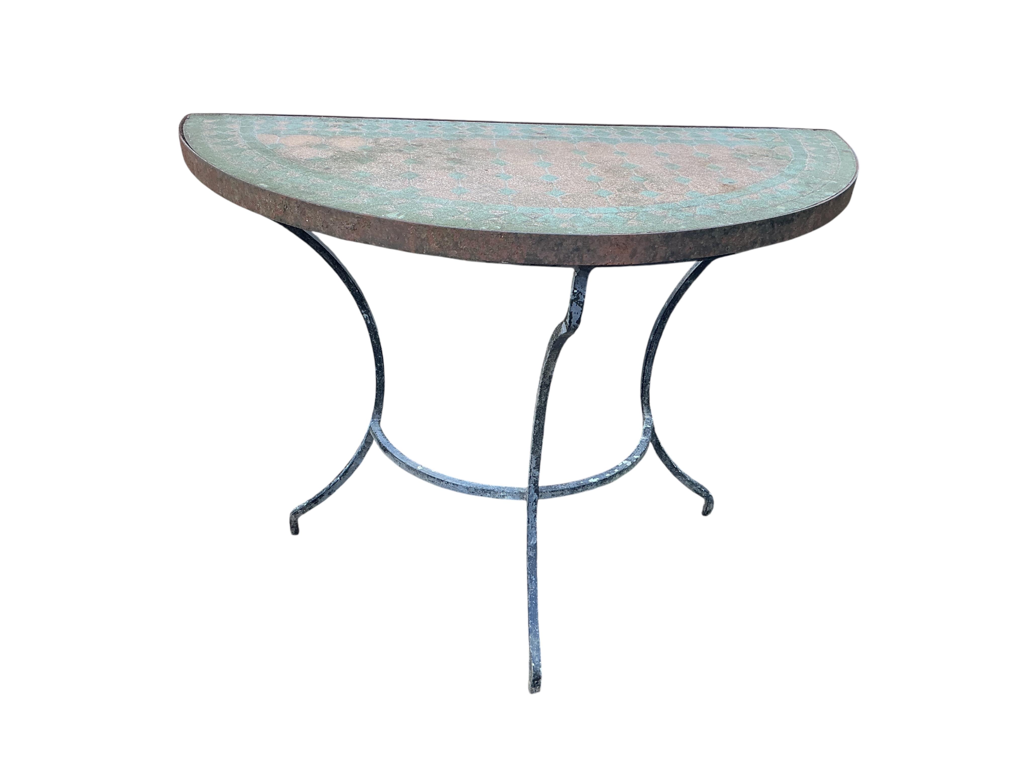 A mosaic topped demi-lune wrought iron garden table, width 96cm and a circular metal folding table with two chairs (requiring new bolts)